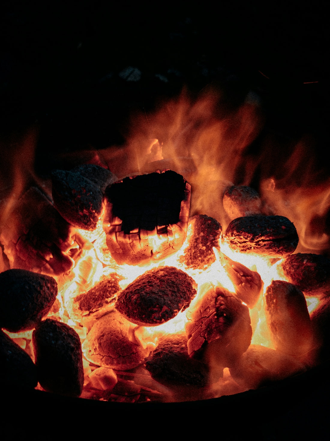 a close up of a fire with rocks in it