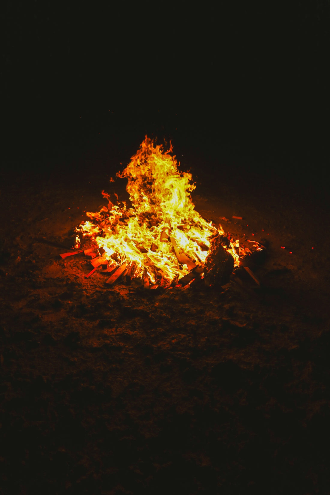 A fire is lit up in the dark
