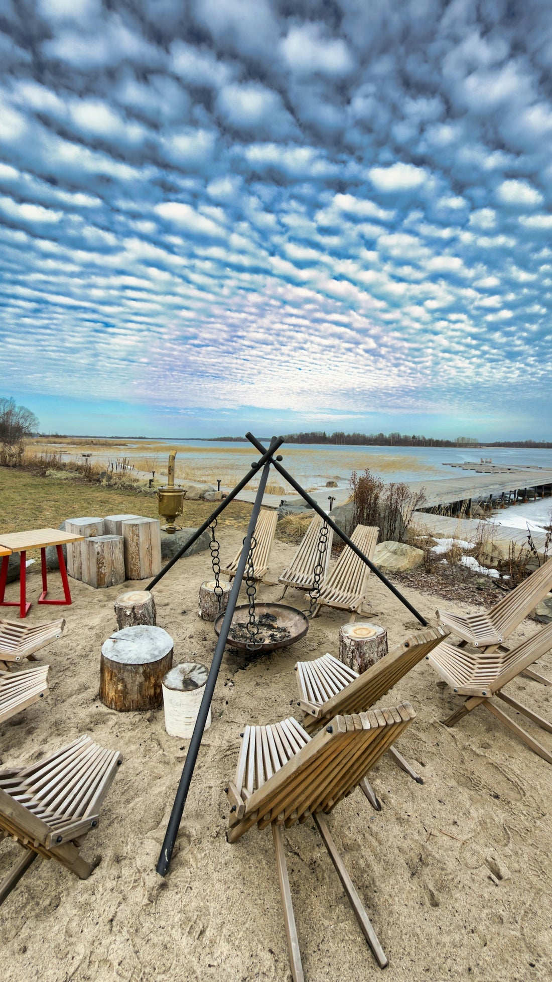 Outdoor seating area with campfire pit and chairs.