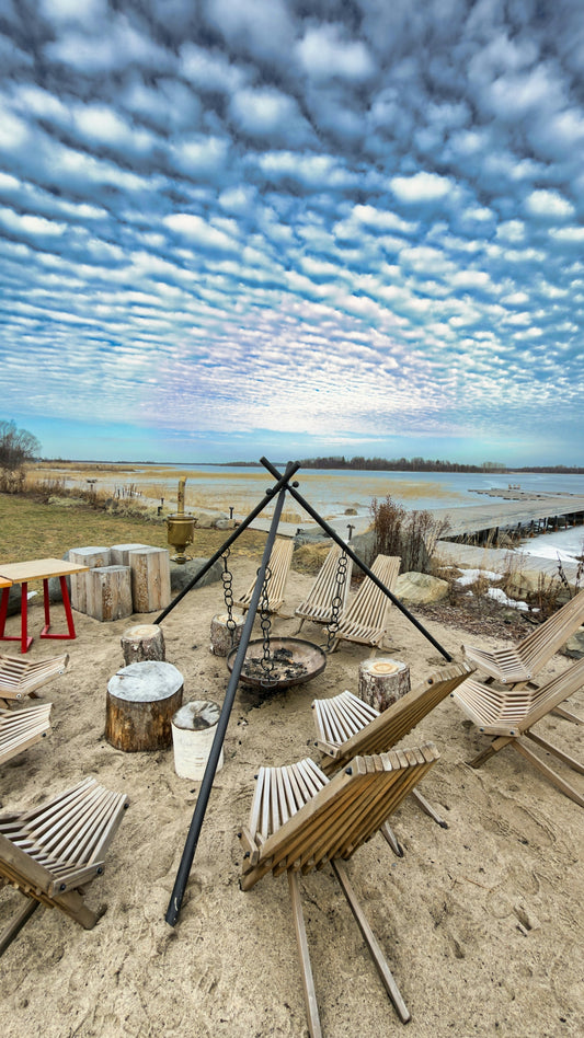 Outdoor seating area with campfire pit and chairs.