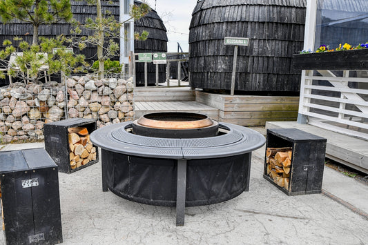 Modern outdoor fire pit with seating and firewood